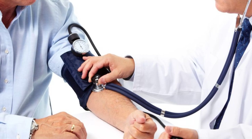 Doctor measuring blood pressure of a patient